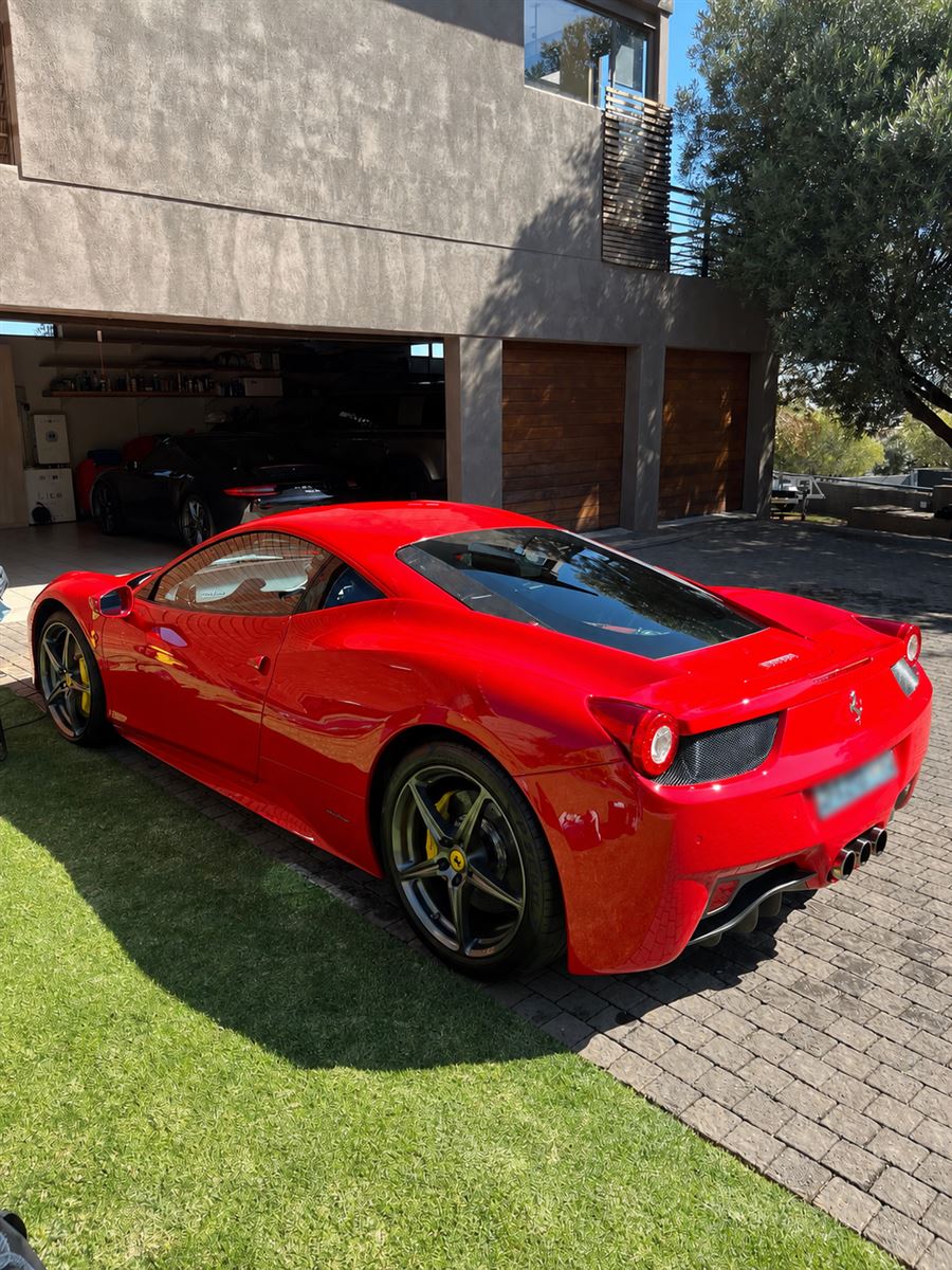 Red Ferrari 458 Italia rear three-quarter with a deep gloss finish